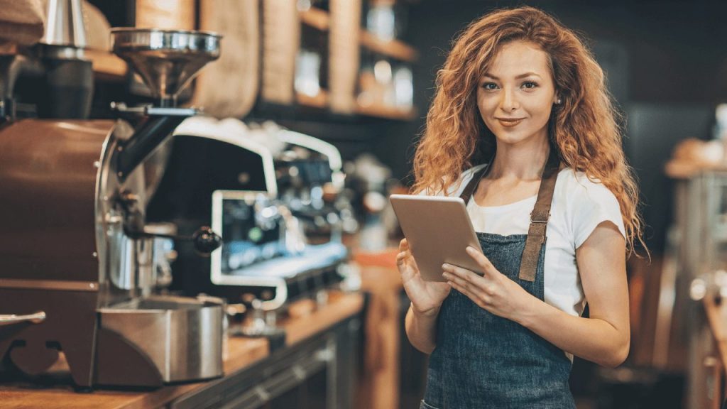 coffee shop employee using kiosk mode on android tablet for taking orders